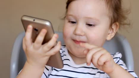 Baby-girl-talking-on-the-phone,-surprised-and-laughing