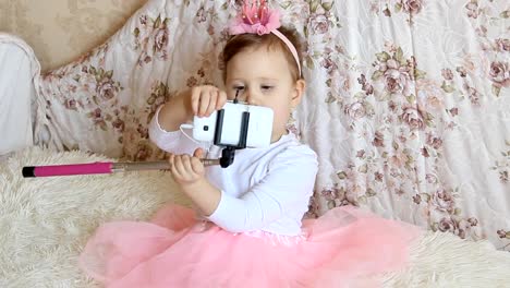 A-little-beautiful-funny-girl-takes-pictures-of-Selfie-on-the-phone