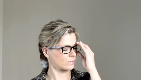 Beautiful-business-woman-with-glasses-tired-after-work