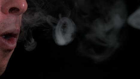 Man-smoking-a-Cigarette-against-Black-Background,-Slow-Motion-4K