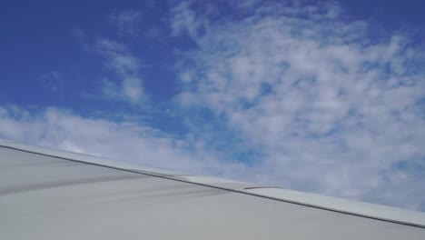 Flugzeug-Fenster-mit-Blick-auf-die-Wolken-vom-Beifahrersitz