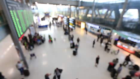 Top-view-of-abstract-blur-airport-terminal-with-commuter-crowd-of-people-and-passenger-walking-when-track-arriving-or-departing-flights,-Blurred-busy-Airport-Terminal-footage-concept.-Full-HD1920x1080