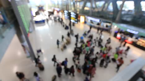 Top-view-of-abstract-blur-airport-terminal-with-commuter-crowd-of-people-and-passenger-walking-when-track-arriving-or-departing-flights,-Blurred-busy-Airport-Terminal-footage-concept.-Full-HD1920x1080