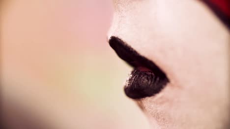 The-makeup-artist-applying-black-color-on-the-lips