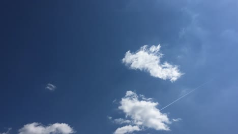 White-cloud-disappear-in-the-hot-sun-on-blue-sky.-Cumulus-clouds-form-against-a-brilliant-blue-sky.-Time-lapse-motion-clouds-blue-sky-background.