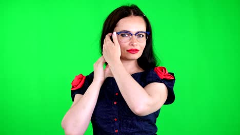 green-background,-chromeakey.-portrait-of-a-sexy-brunette-woman-with-red-lips,-in-stylish-glasses,-spectacles,-eroticly,-playfully-moves,-looking-sexually-at-camera,-posing-in-studio