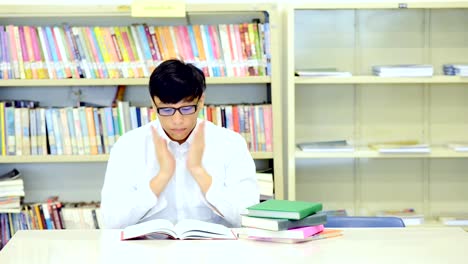 Study-hard-in-library.-Young-Chinese-boy-study-hard-at-library.-Fall-to-sleep.