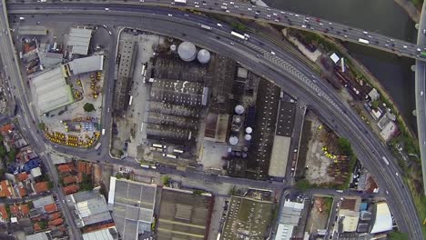 aerial-flying-over-industrial-warehouses-and-road-networks