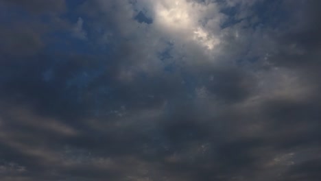 White-sunset-clouds-disappear-in-the-hot-sun-on-blue-sky.-Loop-features-time-lapse-motion-night-clouds-backed-by-a-beautiful-blue-sky.-Time-lapse-motion-clouds-blue-sky-background-and-sunset-sun.