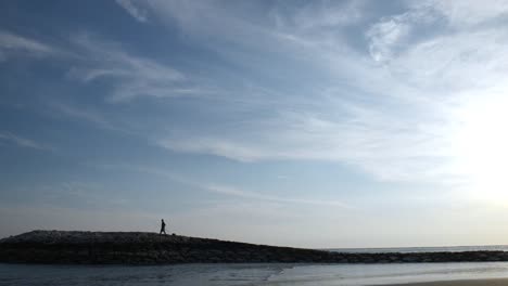 Fisherman-Walking-on-Dyke-in-Sunset