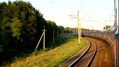 The-movement-of-the-train-at-a-sunset.