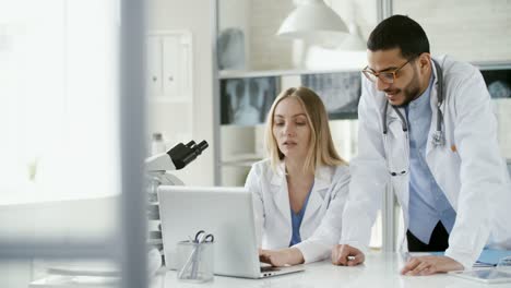 Multiethnic-Biologists-Using-Laptop-Computer