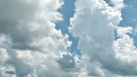 Beautiful-cloudscape-with-large,-building-clouds-and-sunrise-breaking-through-cloud-mass.