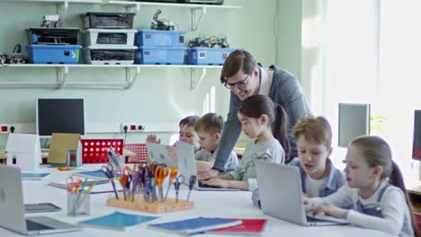 Male-Teacher-Helping-Girl-in-Class