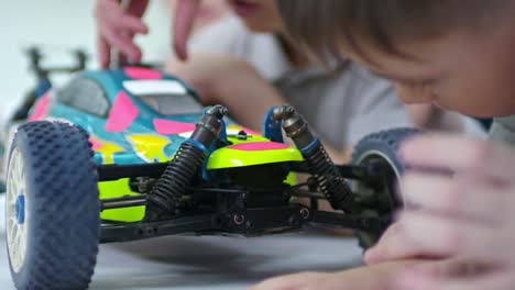 Boy-Studying-Mechanisms-of-Toy-Car