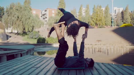 Beautiful-couple-practicing-acro-yoga-in-the-morning