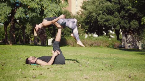 Beautiful-couple-practicing-acro-yoga-in-the-morning