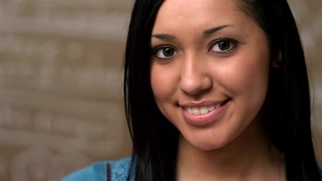 A-young-attractive-female-college-student-looks-into-the-camera-and-smiles