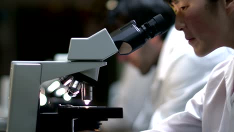 Students-in-a-lab-look-through-a-microscope-during-their-experiments