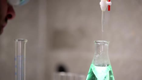 A-university-student-conducts-experiments-during-a-chemistry-lab-class