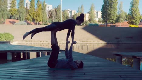 Beautiful-couple-practicing-acro-yoga-in-the-morning