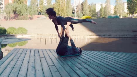 Beautiful-couple-practicing-acro-yoga-in-the-morning