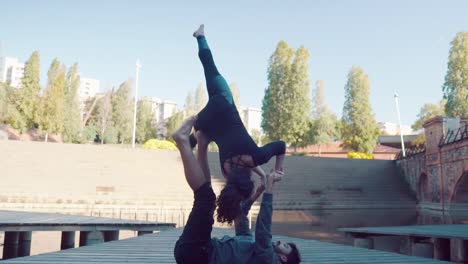 Beautiful-couple-practicing-acro-yoga-in-the-morning