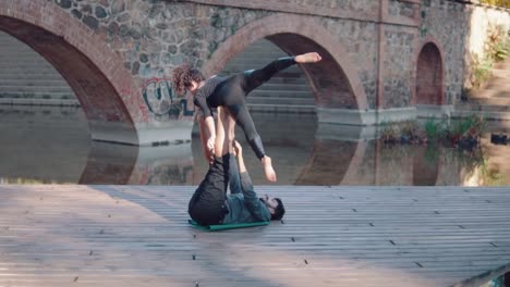 Beautiful-couple-practicing-acro-yoga-in-the-morning