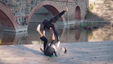 Beautiful-couple-practicing-acro-yoga-in-the-morning