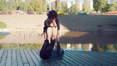 Beautiful-couple-practicing-acro-yoga-in-the-morning