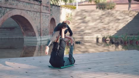 Beautiful-couple-practicing-acro-yoga-in-the-morning