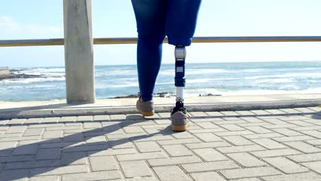 Low-section-of-disabled-woman-walking-on-promenade-near-railing-4k