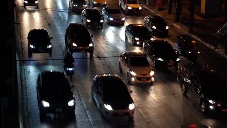 Traffic-during-rush-hour,-vehicles-driving-on-multiple-lane-road-at-dark-time