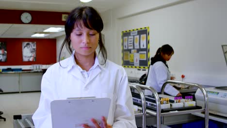 Laboratory-technician-looking-at-clipboard-4k