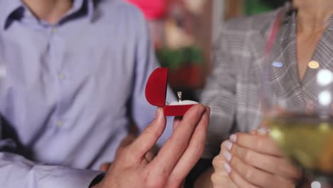 Man-Doing-Marriage-Proposal-To-Woman-In-Restaurant-Closeup