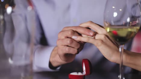 Marriage-Proposal.-Closeup-Man-Wearing-Ring-On-Woman's-Hand