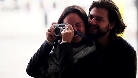 Happy-couple-in-love-taking-pictures-during-vacation.