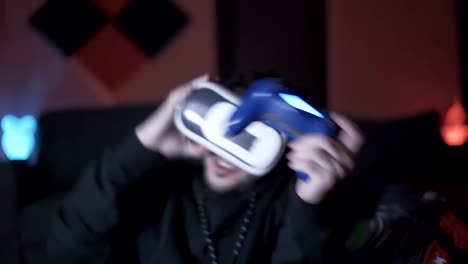 Young-man-playing-game-throwing-VR-glasses-and-controller-scared-from-the-game