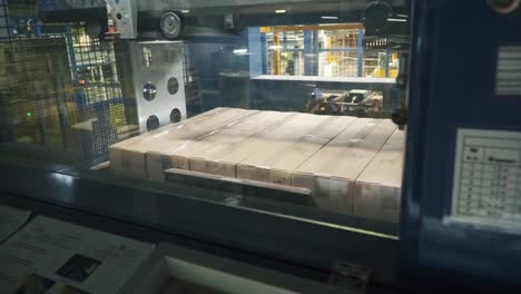 Cardboard-boxes-on-conveyor-belt-in-factory.-Clip.-Packing-products-in-a-box-at-the-factory