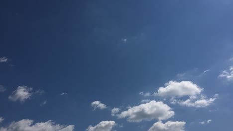 White-cloud-disappear-in-the-hot-sun-on-blue-sky.-Cumulus-clouds-form-against-a-brilliant-blue-sky.-Time-lapse-motion-clouds-blue-sky-background.