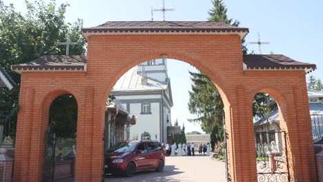 orthodox-church,-the-entrance-gate-to-the-territory-of-the-Orthodox-church,-the-arch,-sunny-day,-green-trees