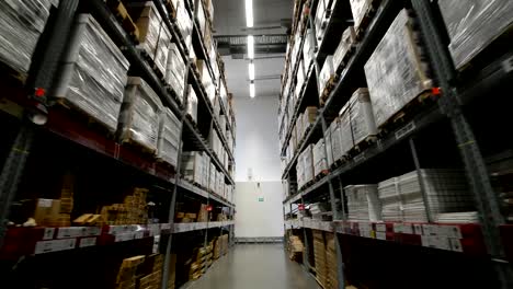 Moving-between-palettes-with-cardboard-boxes-and-different-materials-in-a-storage-warehouse