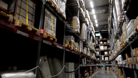 Camera-moves-in-huge-industrial-warehouse,-business-shipping-and-cargo-storage-for-export