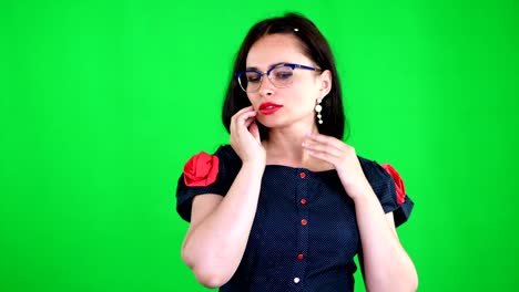 green-background,-chromeakey.-portrait-of-a-sexy-brunette-woman-with-red-lips,-in-stylish-glasses,-spectacles,-eroticly,-playfully-moves,-looking-sexually-at-camera,-posing-in-studio