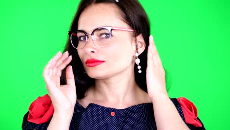 green-background,-chromeakey.-portrait-of-a-sexy-brunette-woman-with-red-lips,-in-stylish-glasses,-spectacles,-eroticly,-playfully-moves,-looking-sexually-at-camera,-posing-in-studio