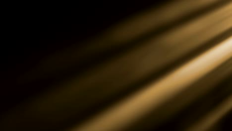 gold-warm-color-bright-lens-flare-rays-flashes-leak-movement-for-transitions-on-black-background,movie-titles