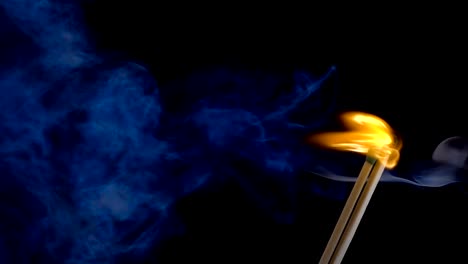 Burning-match-on-a-black-background-in-slow-motion