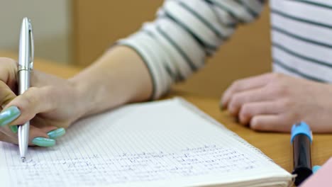 Manos-de-estudiante-tomar-el-examen-en-la-Universidad-de