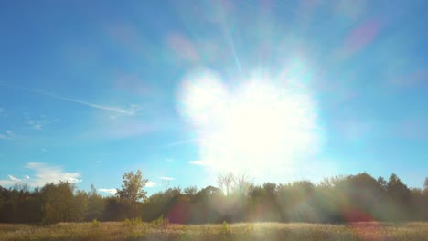 Hermosa-luz-del-sol-en-el-cielo-azul-sobre-el-bosque-y-Prado.