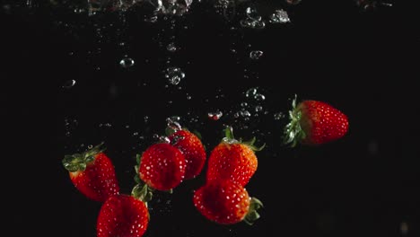 SLOW-MOTION:-Strawberries-fall-in-water